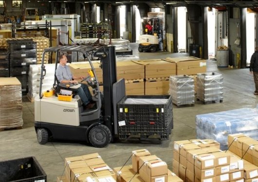 Crown forklift operating in a warehouse, efficiently moving pallets and materials - Thompson Lift Truck