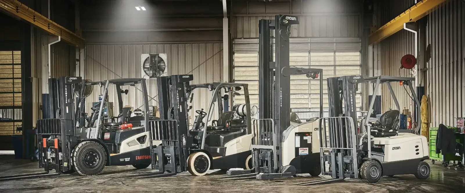 Crown forklifts lined up in warehouse for rent, showing reasons to rent a forklift from Thompson Lift Truck across the Southeast