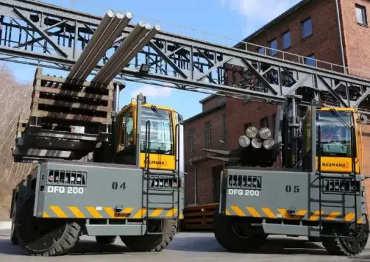 Heavy-duty sideloader southeast forklifts carrying long steel loads at Thompson Lift Truck